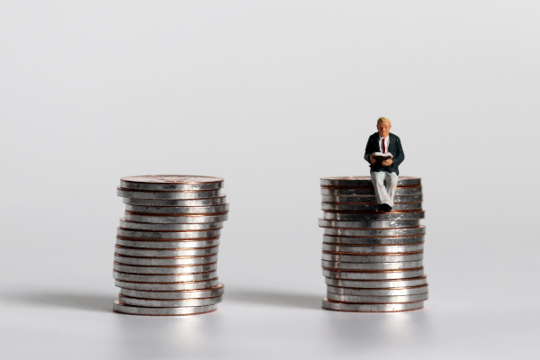 man sitting on a pile of coins